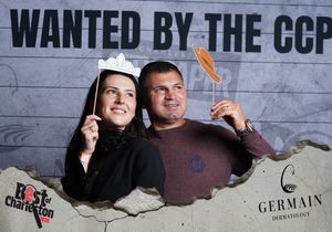Man and woman pose with crown and mustache props at Best of Charleston CCP photo booth.