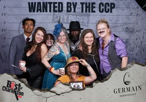 Group of seven friends pose at Best of Charleston Wanted by the CCP photo booth event.