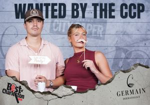 Young couple poses with mustache props at Best of Charleston CCP City Paper photo booth.