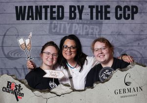 Three women posing together at the Wanted by the CCP Best of Charleston photo booth event.
