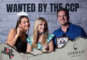 Three people smiling at Best of Charleston City Paper wanted by the CCP photo booth.