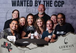 Group of eight people posing together at the Wanted by the CCP Best of Charleston party event.