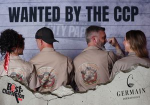 Four people showing matching uniform backs with logo at Wanted by the CCP Charleston event.