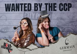 Two women use fun props at Best of Charleston Wanted by the CCP photo booth event.