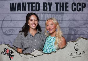 Two smiling women pose at the Wanted by the CCP Best of Charleston event photo booth.