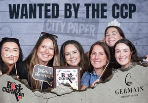 Group of six women pose at Best of Charleston CCP City Paper wanted poster photo booth.