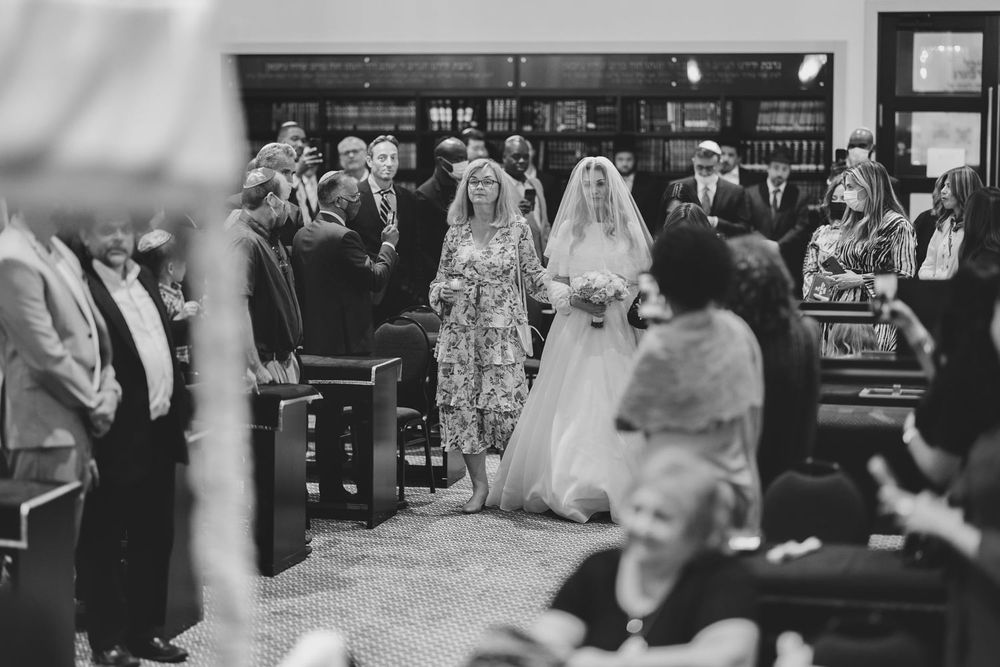Mother walking the bride down the ailse during a wedding in Toronto