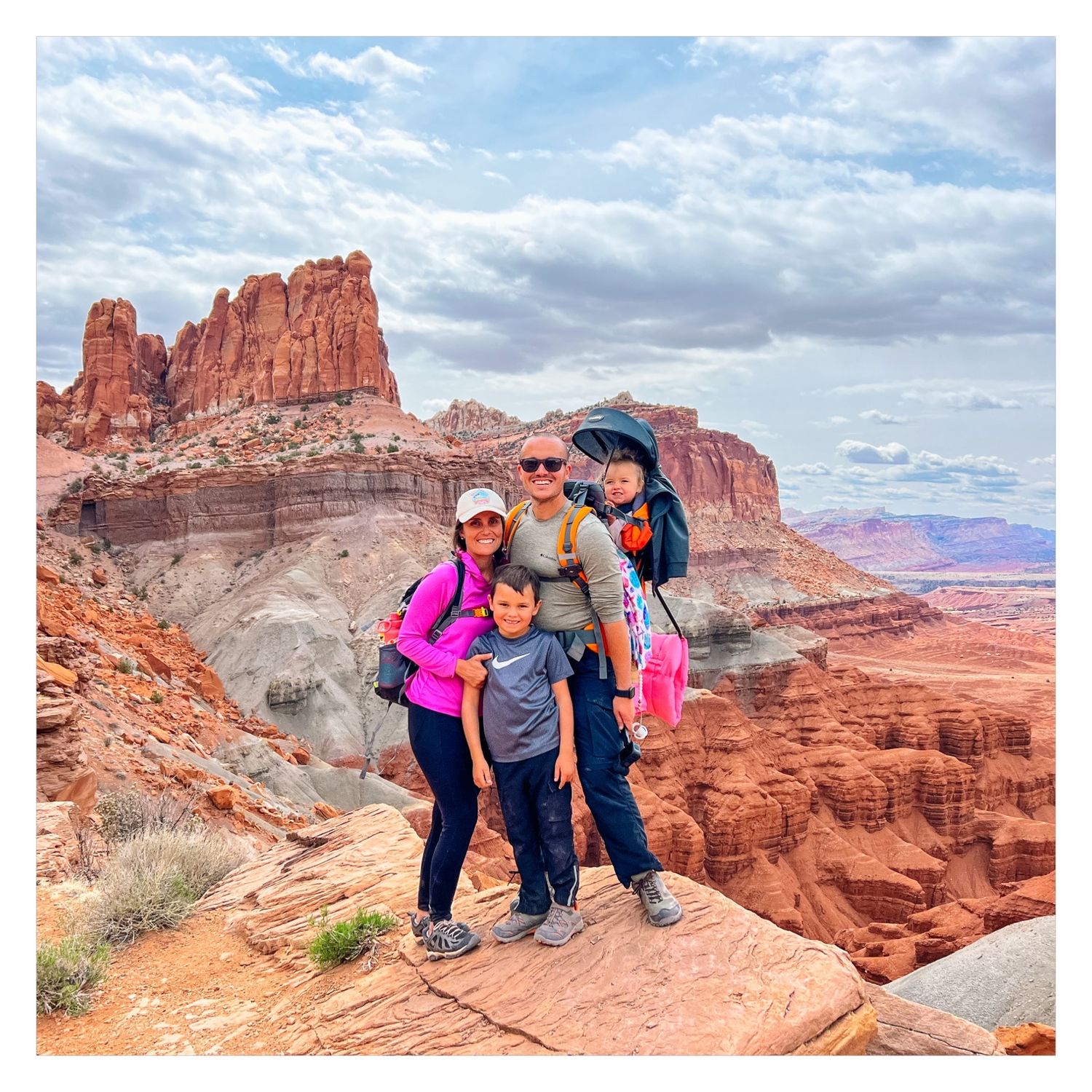 Memory Lain owners, JJ & Ashley, pose with their kids during a family adventure hike in Utah.