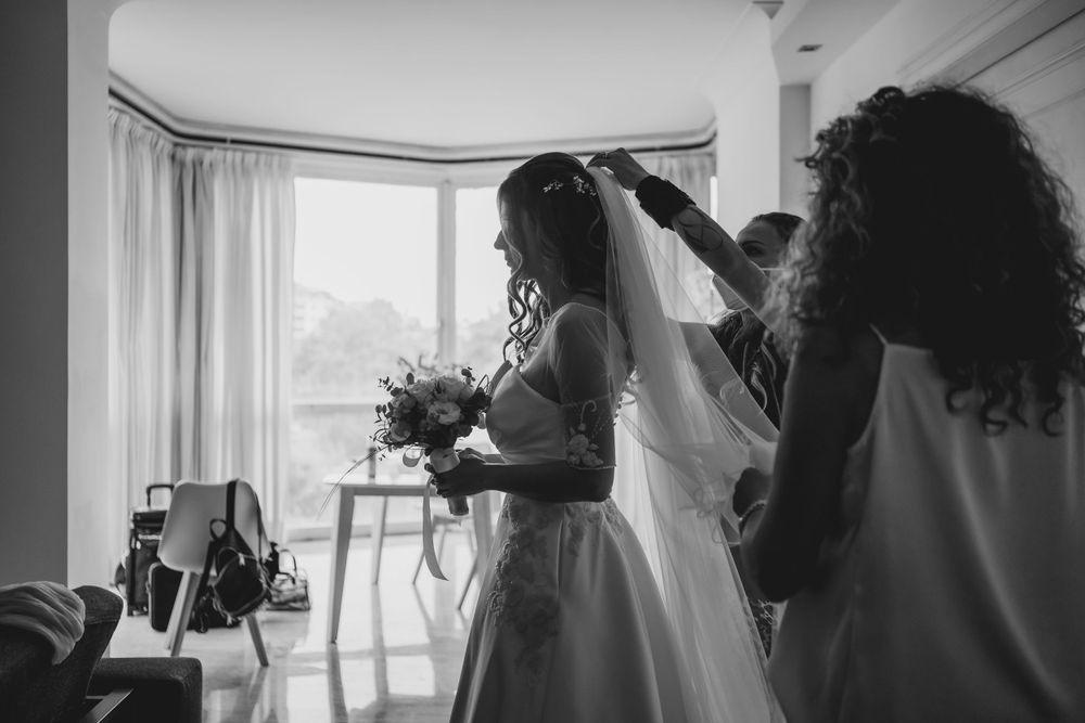 Wedding party silhouettes against bright windows during preparation moments.