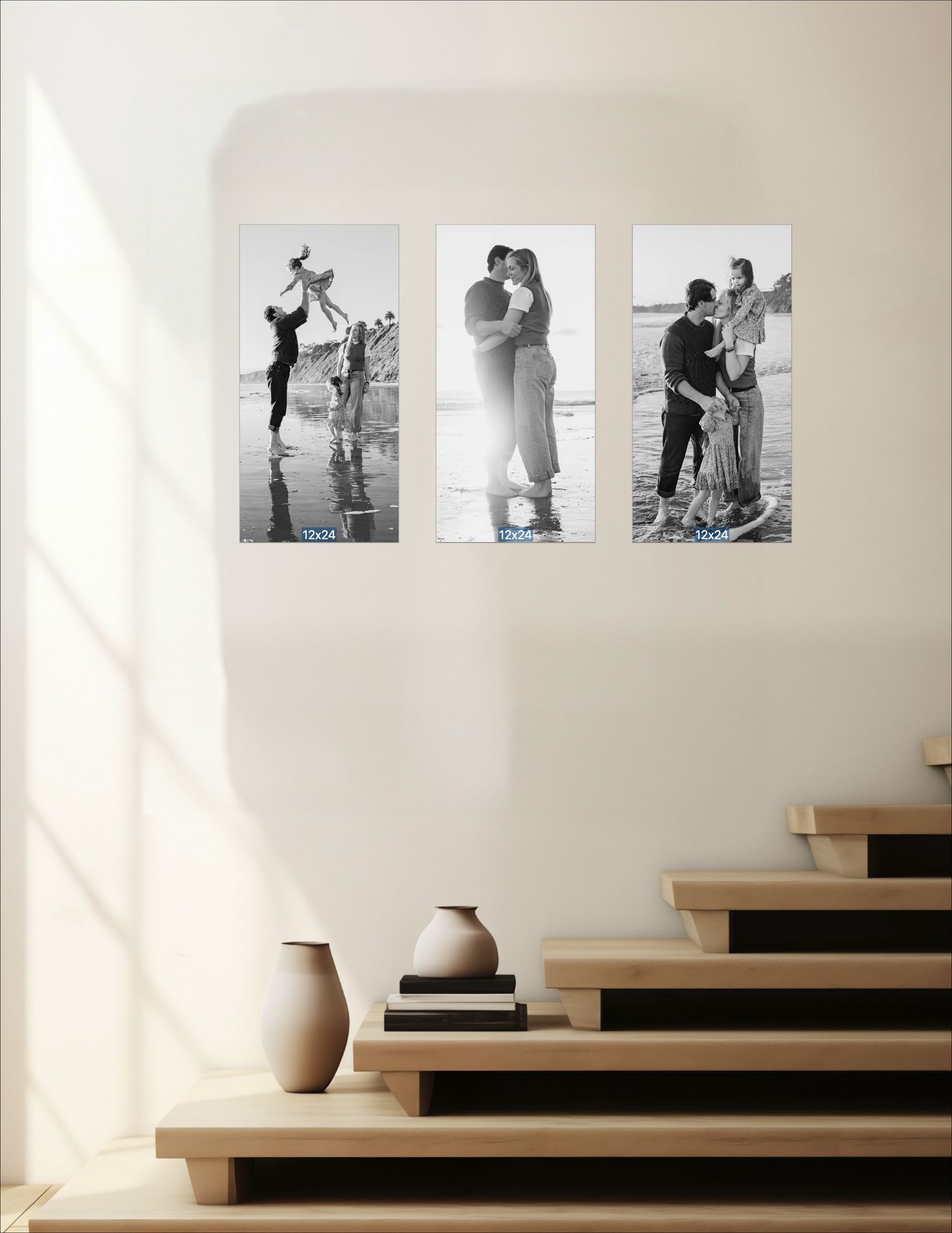 Three black and white romantic couple photos displayed as wall art above wooden stairs in a modern minimalist home interior.