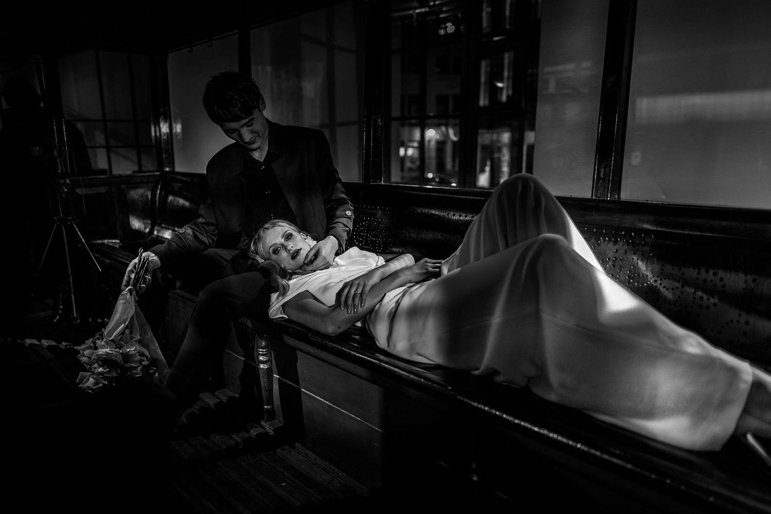 Artistic black and white photo series showing a person in intimate pose in moody lighting.
