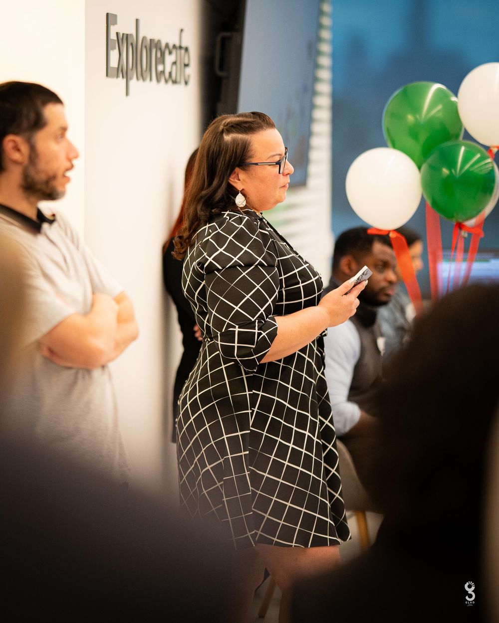 A corporate event with green and white balloons visible near an Empowerstream backdrop.