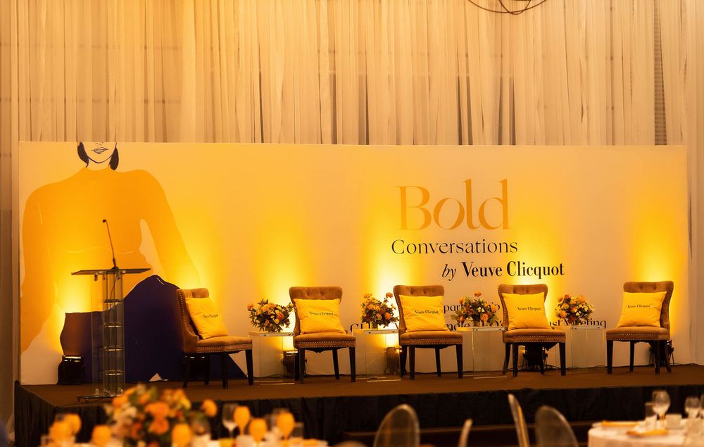 A series of connected conference rooms with warm lighting and modern furniture arranged for professional meetings.