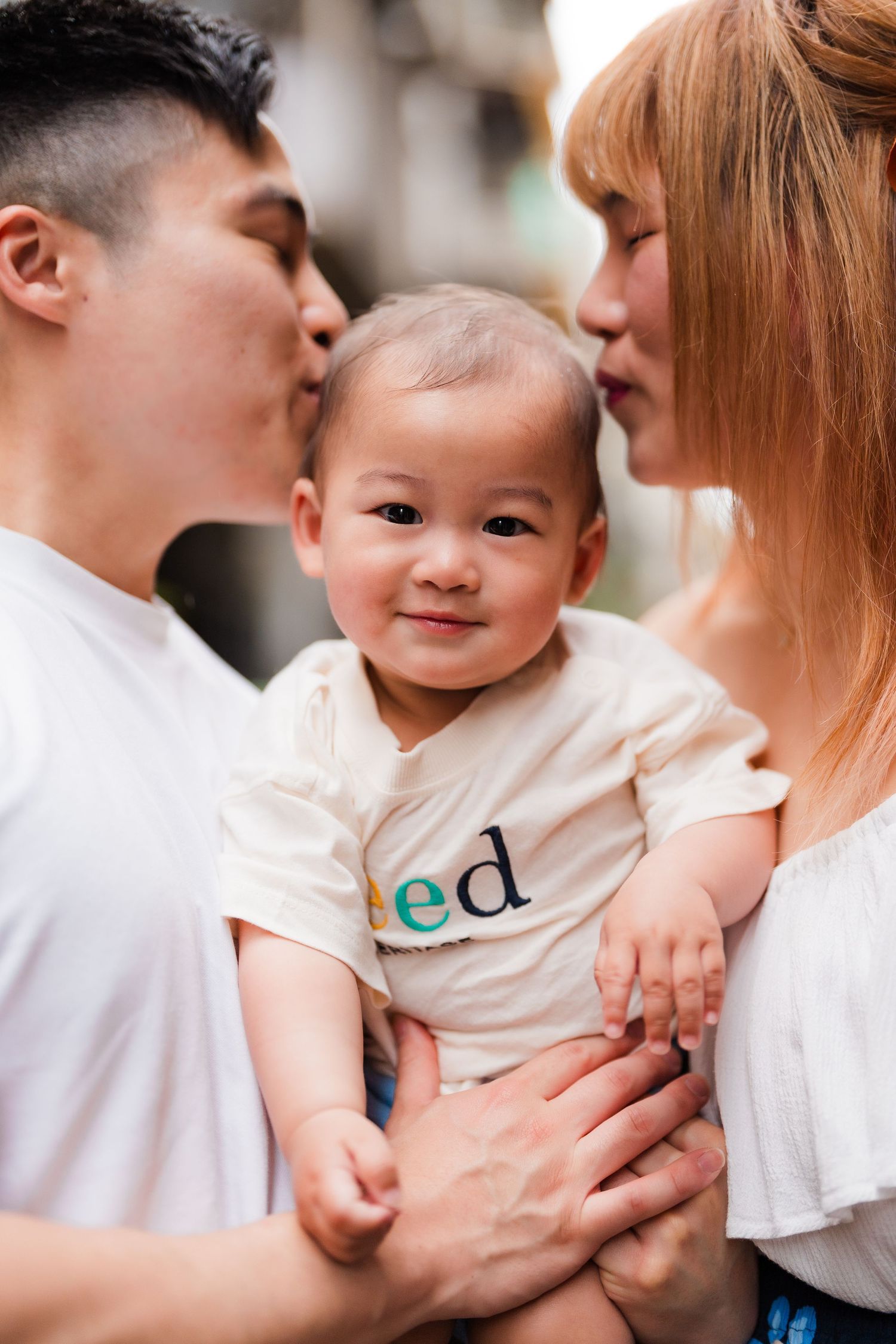 A small family sharing an intimate moment with their baby.