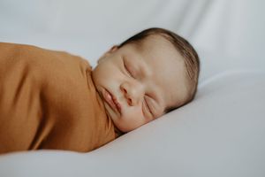 A series of peaceful sleeping baby photos in warm neutral tones showing different angles of peaceful slumber.