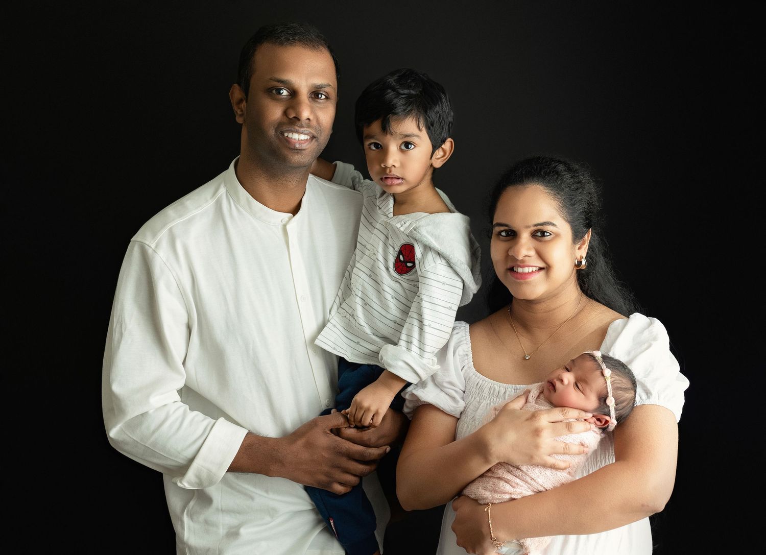 An Indian family holding their newborn. Greenville SC newborn photographer, Easley, SC newborn photographer