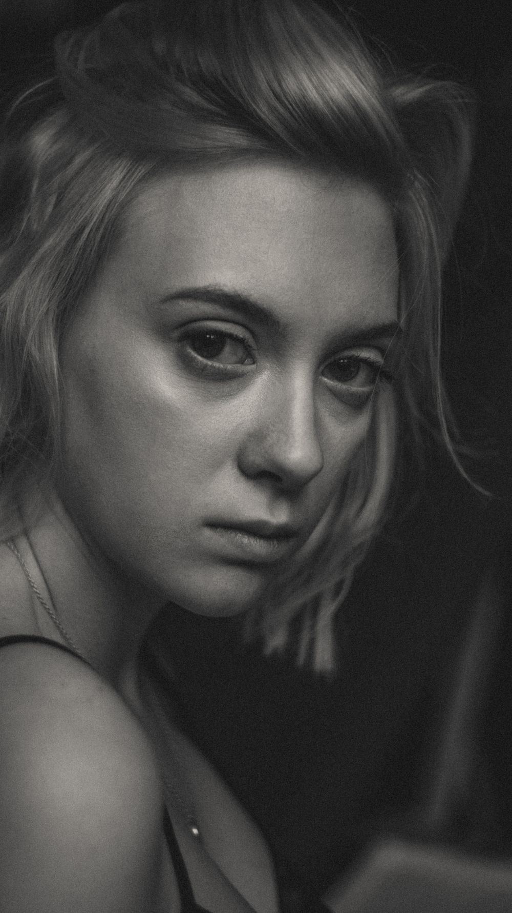 Moody black and white portrait series with dramatic lighting and shadows.