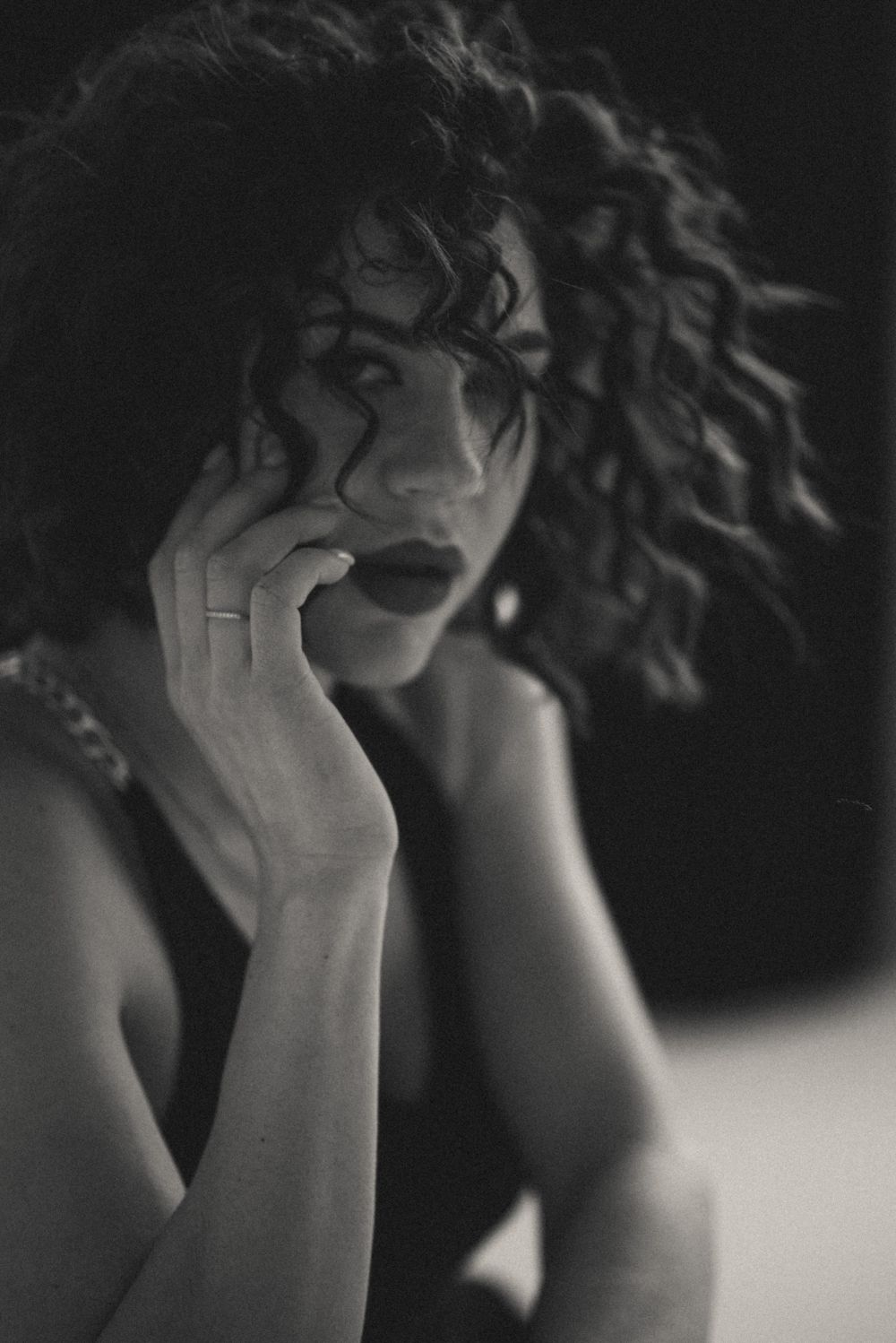 Dramatic black and white close-up series with textured hair and expressive poses.