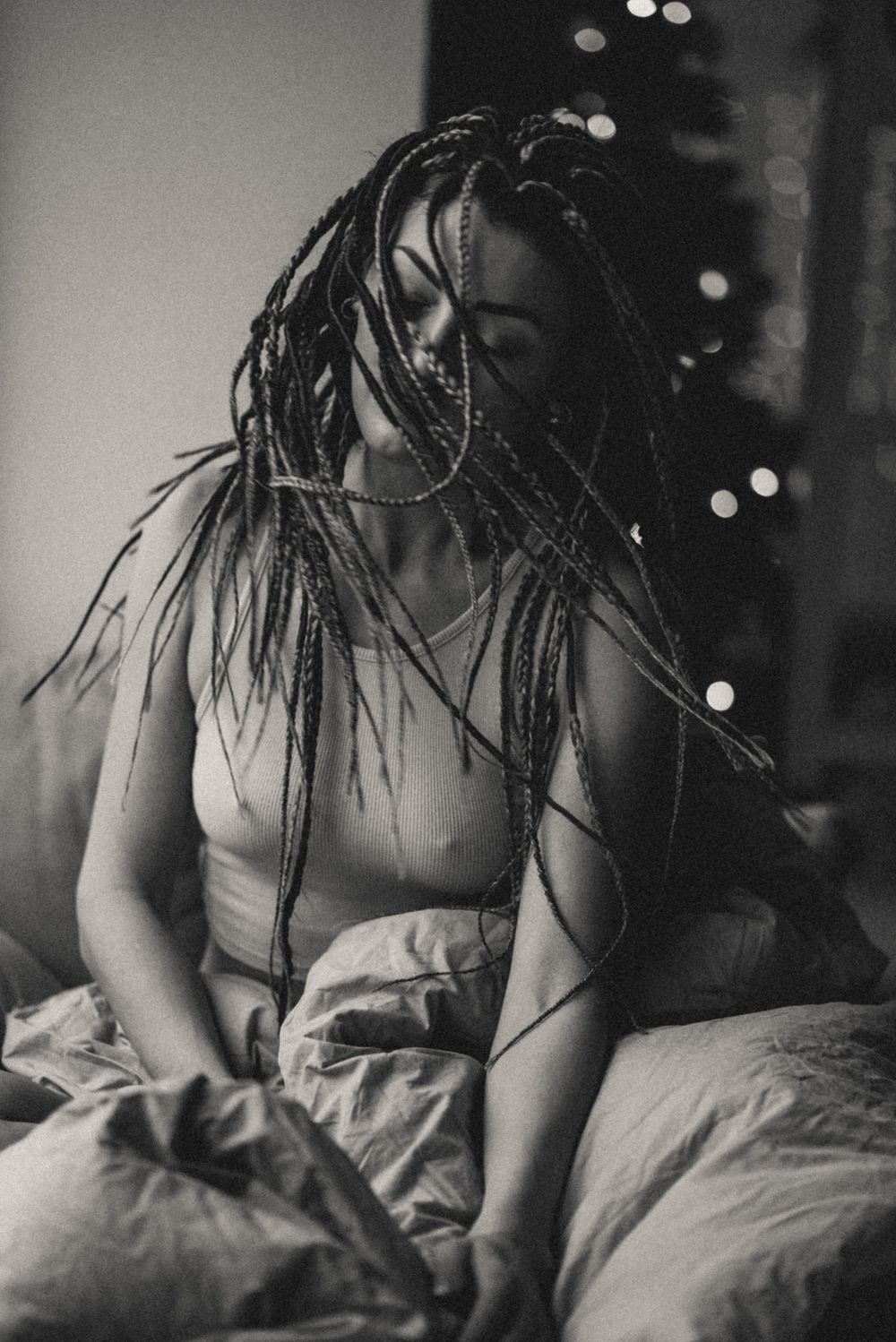 Artistic black and white boudoir photos with moody lighting and dynamic movement.