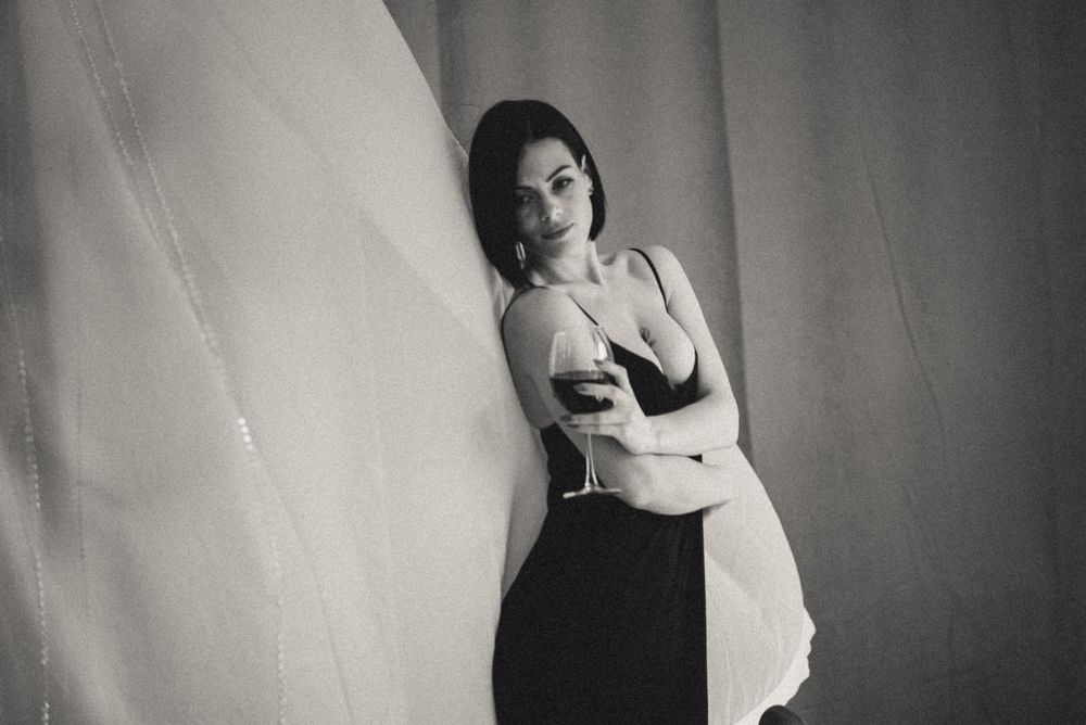 Artistic black and white portraits showing emotional poses against a dark wall.