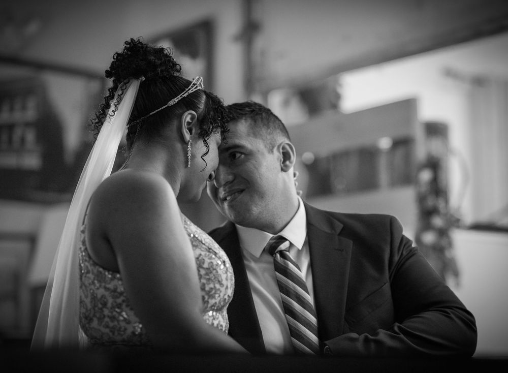 Black and white portrait of bride and groom sharing an intimate moment.