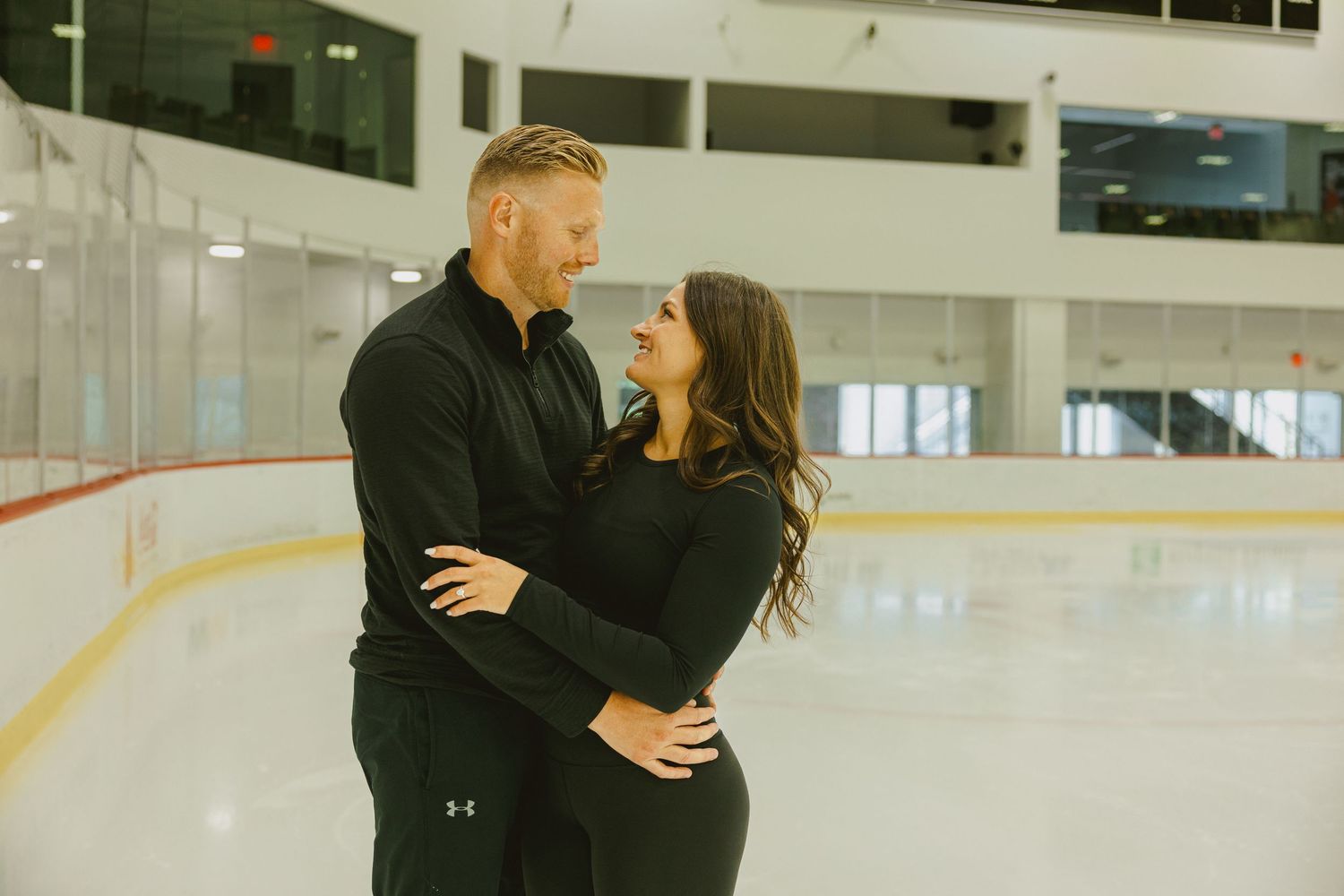 couple embracing on ice skating rink in Fort Lauderdale for engagement shoot
