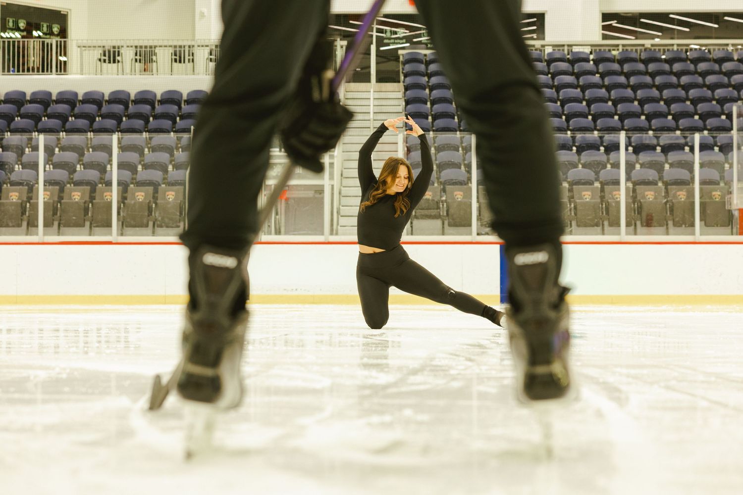 creative shot of figure skater seen through socket players legs for engagement shoot