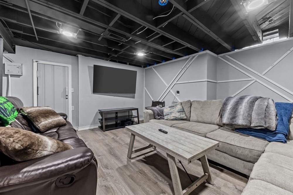 Finished basement rec room with open ceiling and hardwood floors in Dearborn Michigan