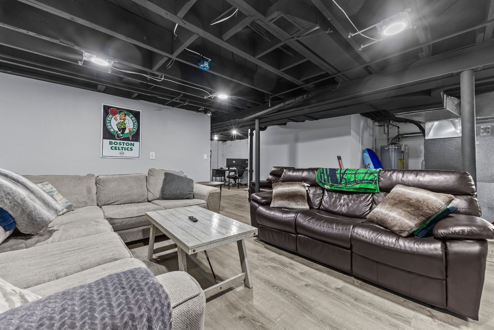 Finished basement rec room with open ceiling and hardwood floors in Dearborn Michigan