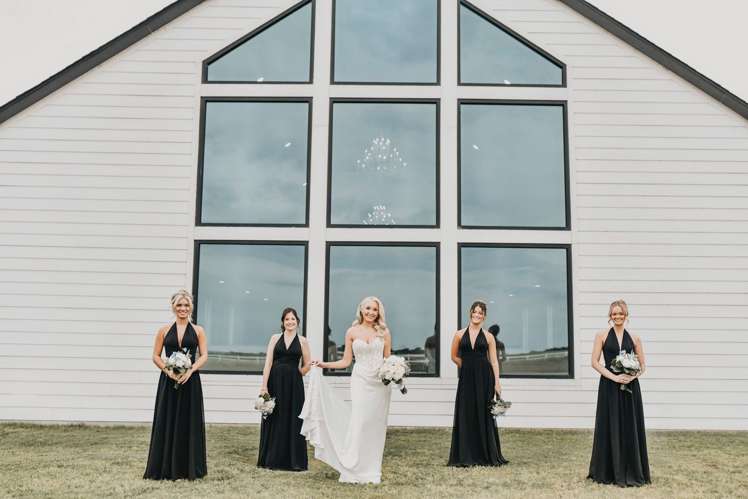 Bridesmaids holding timeless white floral bouquets