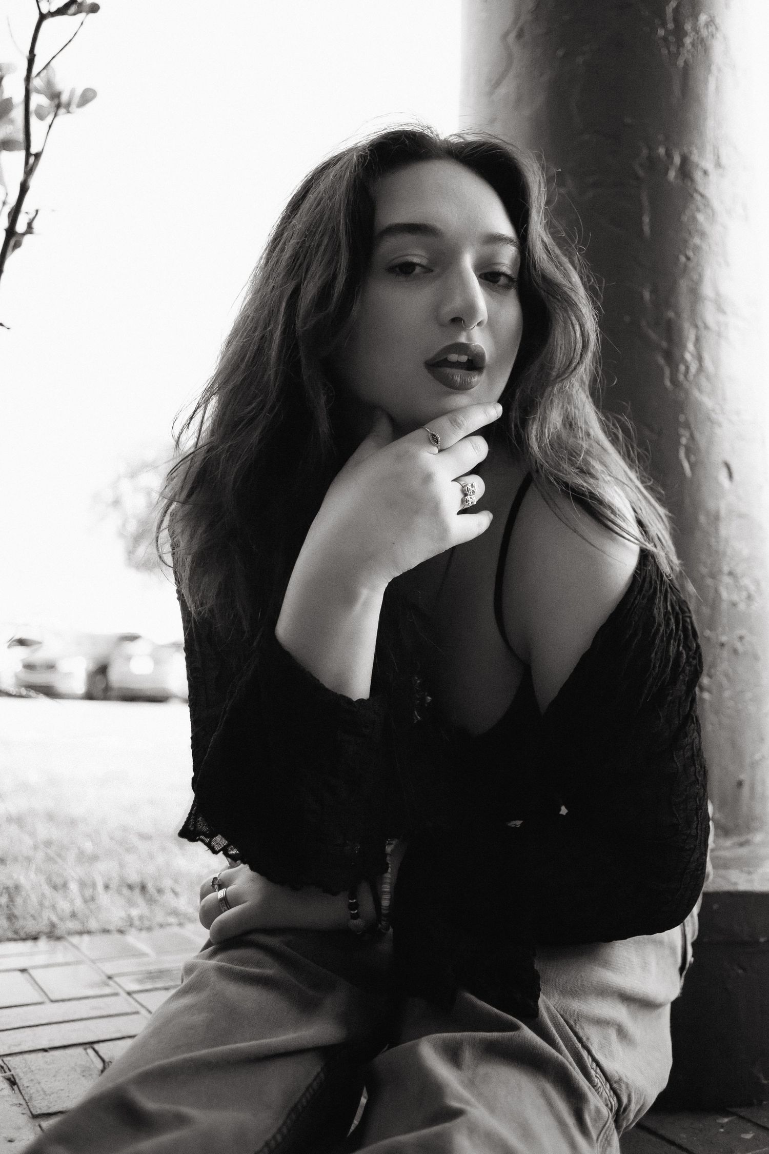 Fashion portrait of woman sitting on sidewalk at Hammocks Town Center in Miami