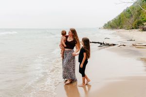 A photo of a mother with her two kids at the lakefront