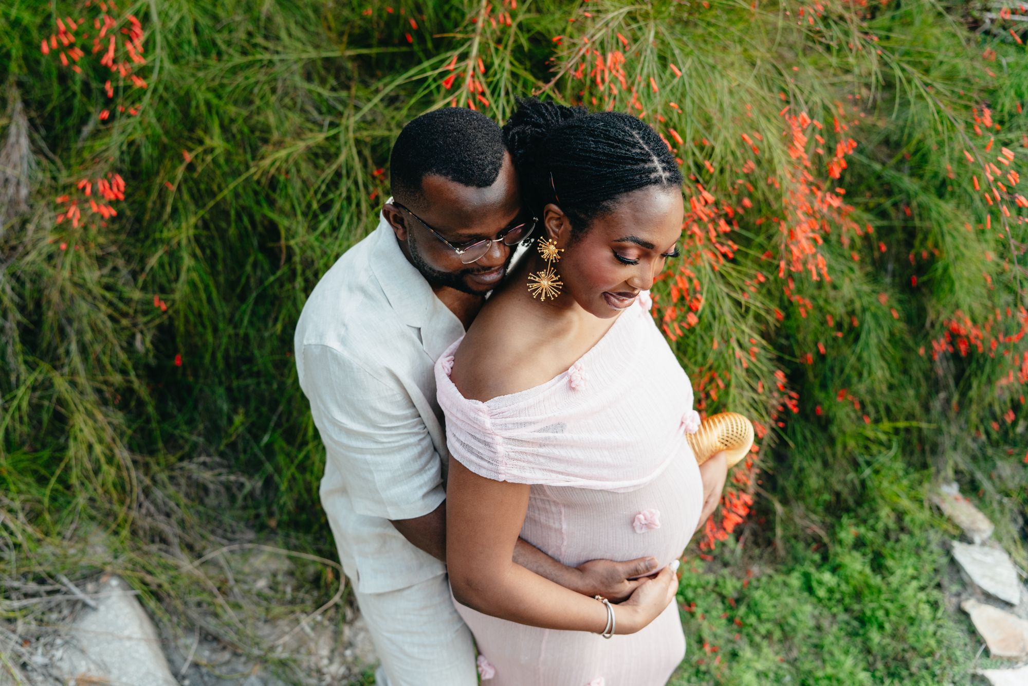 An expecting mother and father embracing