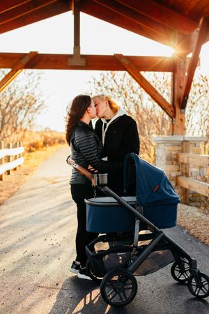 A photo of two mothers kissing