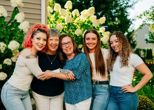 A family of 5 women hugging each other