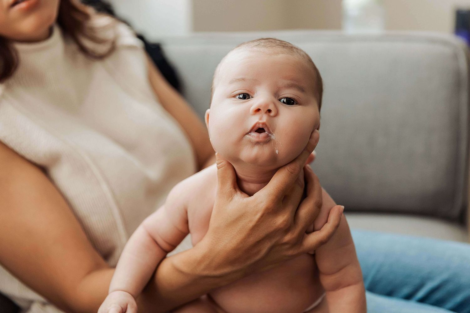 Newborn photography Adelaide — mother holding newborn in natural window light, in-home session Mawson Lakes — Photo By Nancy