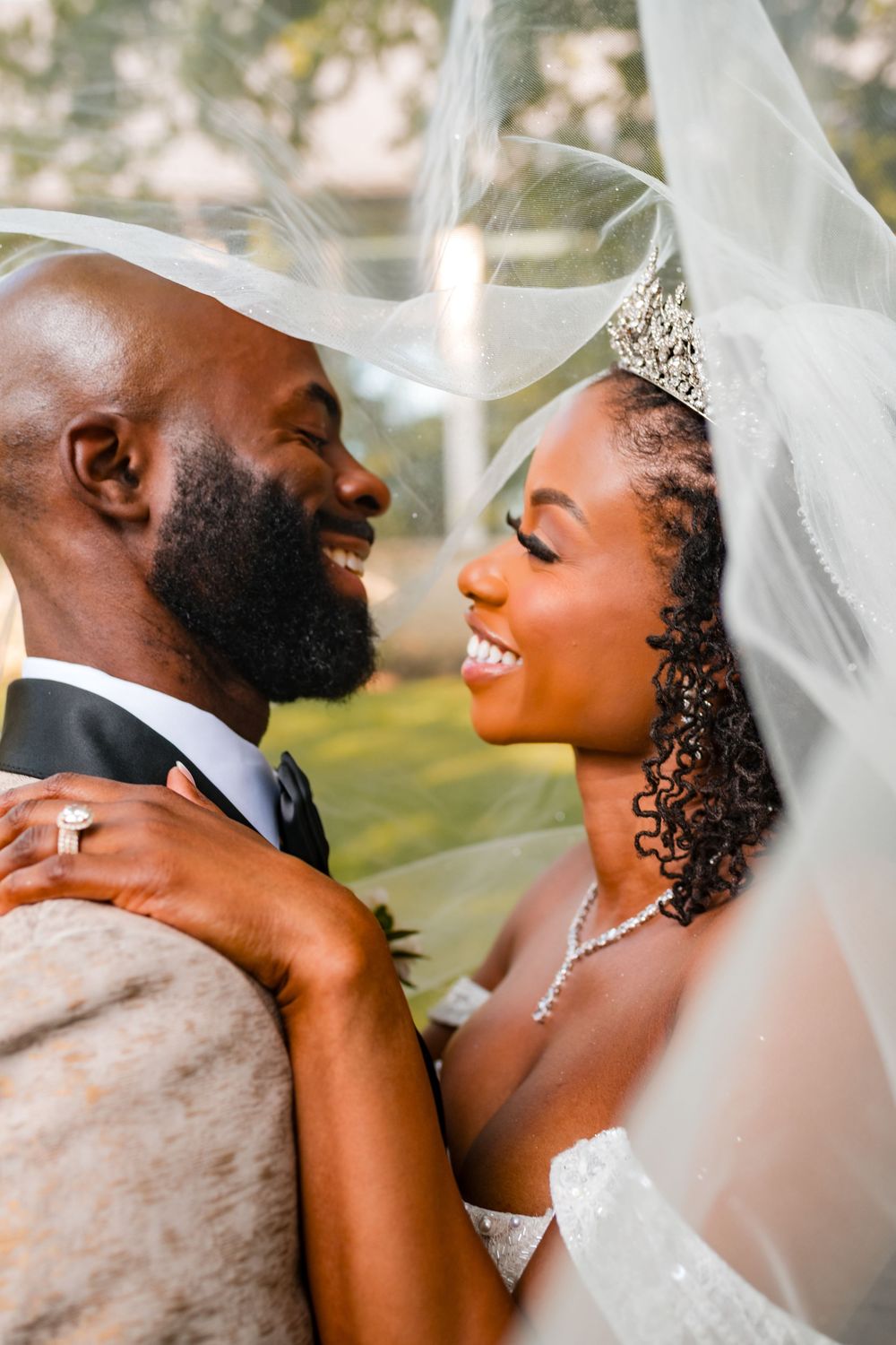 A romantic wedding portrait series showing tender moments between newlyweds with the bride wearing a veil and tiara.