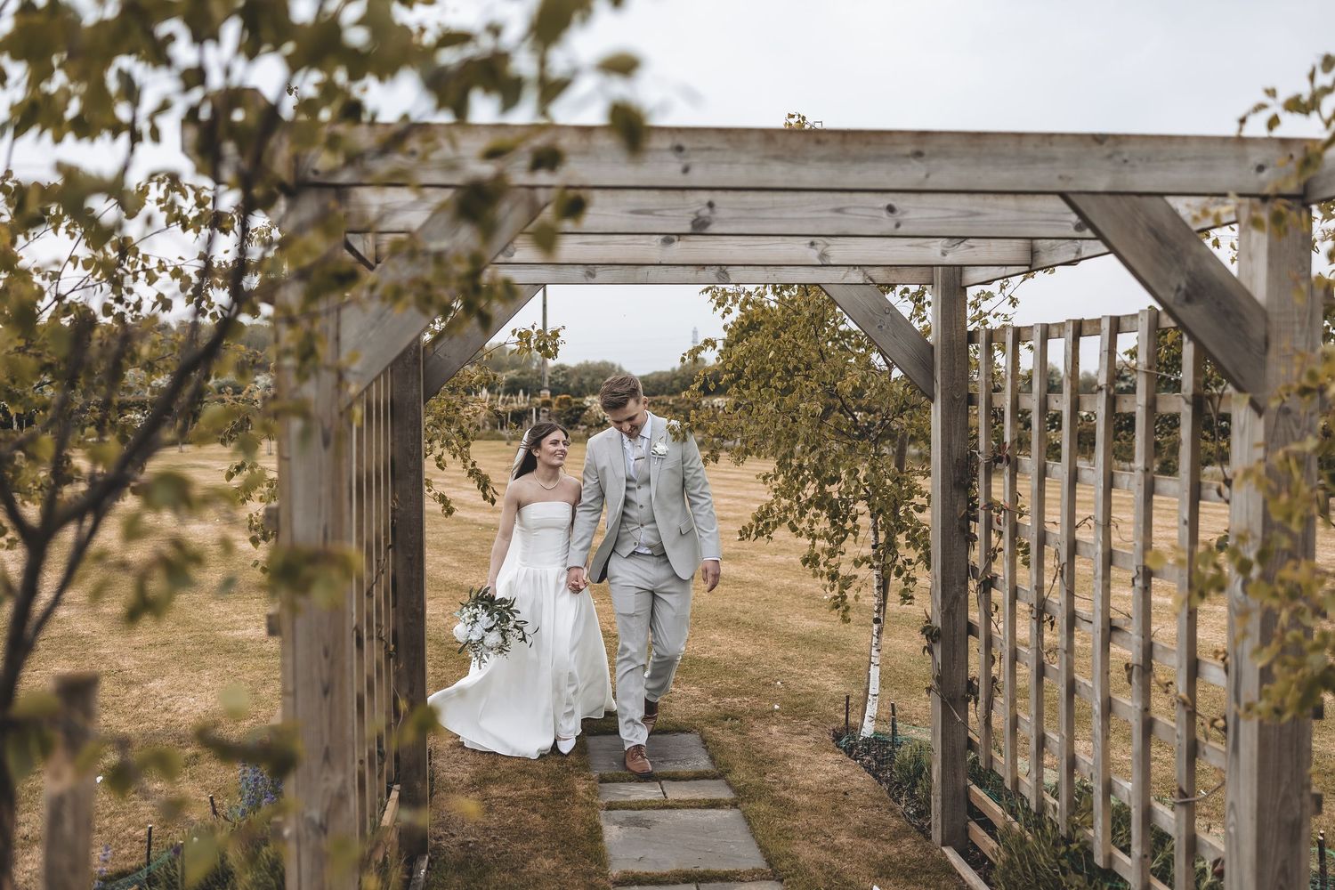 Relaxed wedding couple laughing together during natural wedding photography.