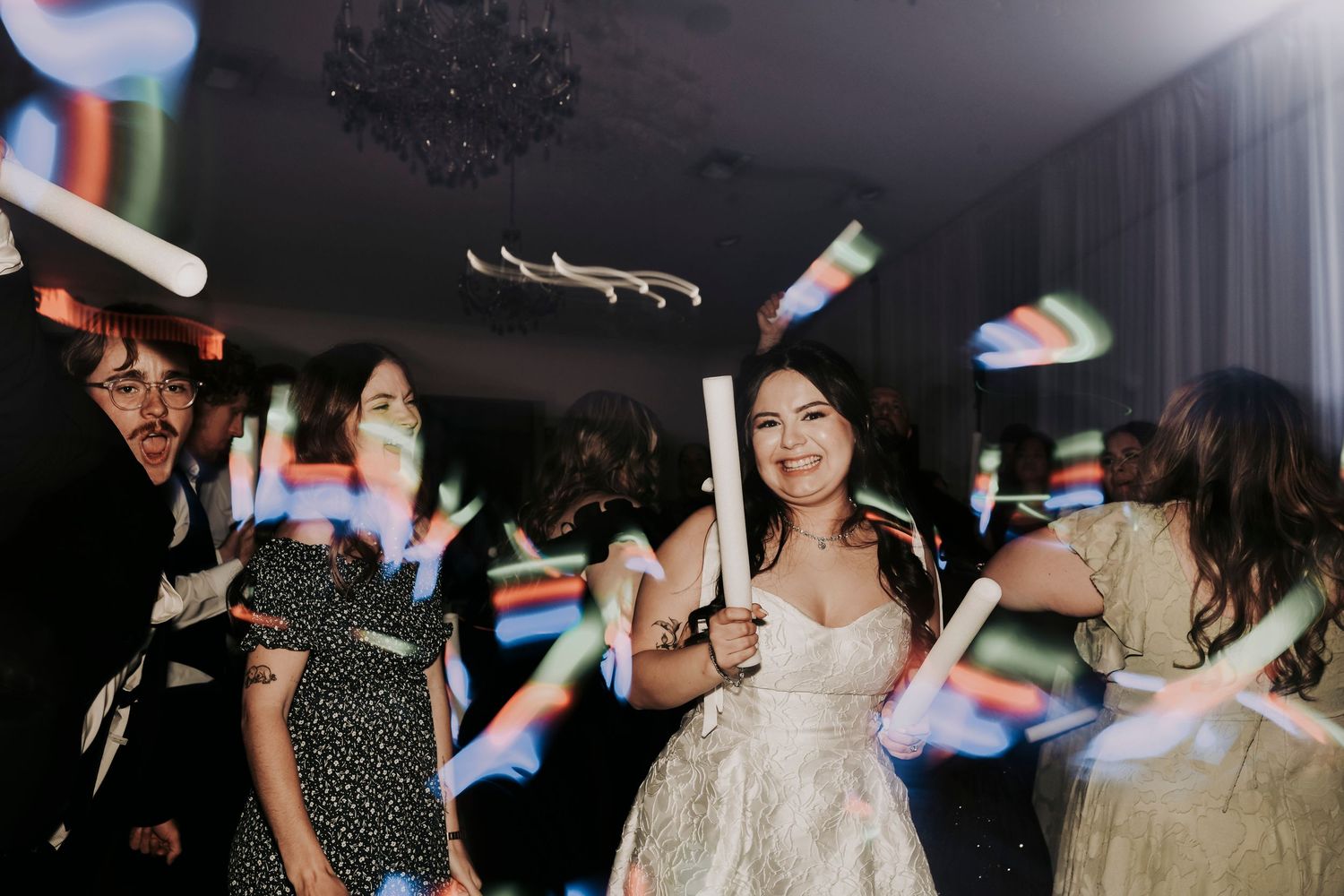 Guests celebrating on the dance floor during wedding reception
