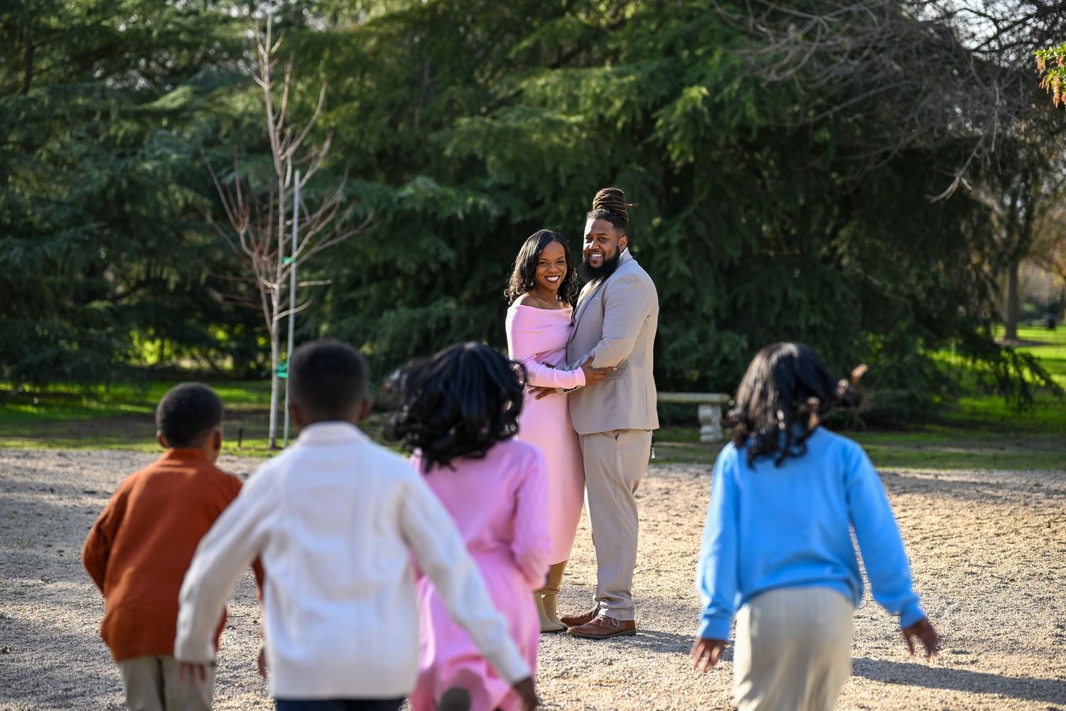 Extended family members walking together on a path during an outdoor photo session.