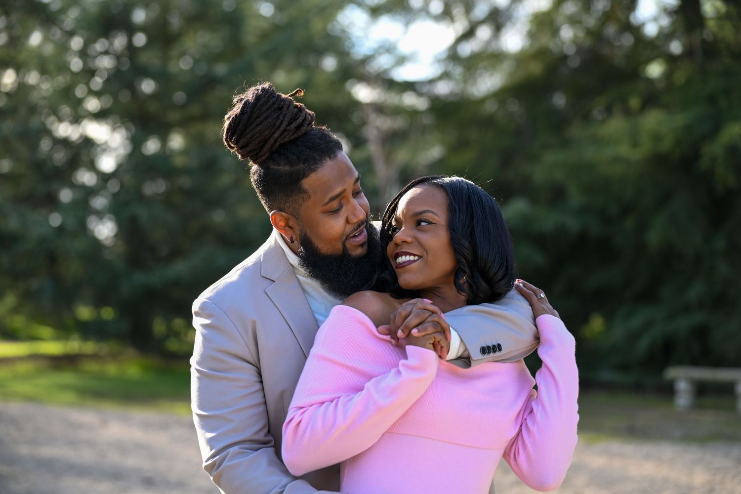 Candid moments of family members embracing and laughing during outdoor photo session.