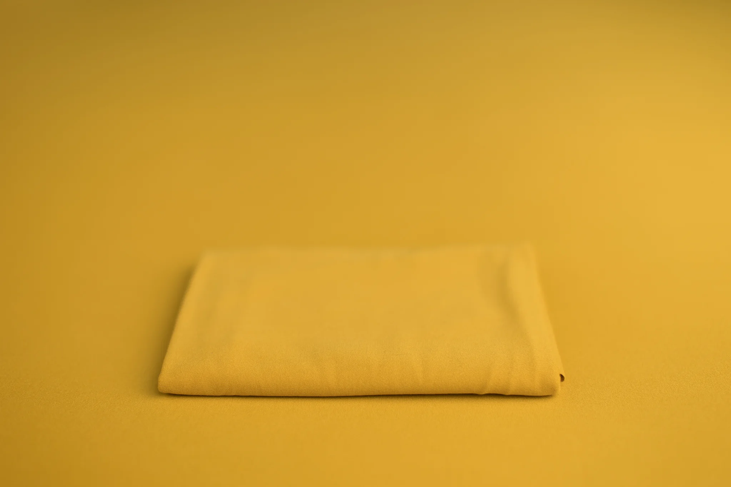 “Neutral yellow tone wrap/backdrop sample for newborn sessions.