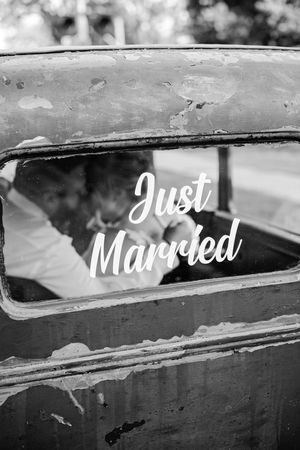 Black and white Just Married text on rustic vintage car window with couple inside.