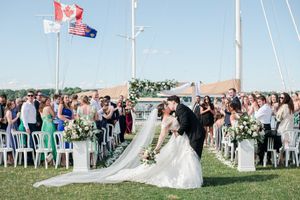 After the ceremony the bride and groom kissing at the end of the aisle in-front of all their guest