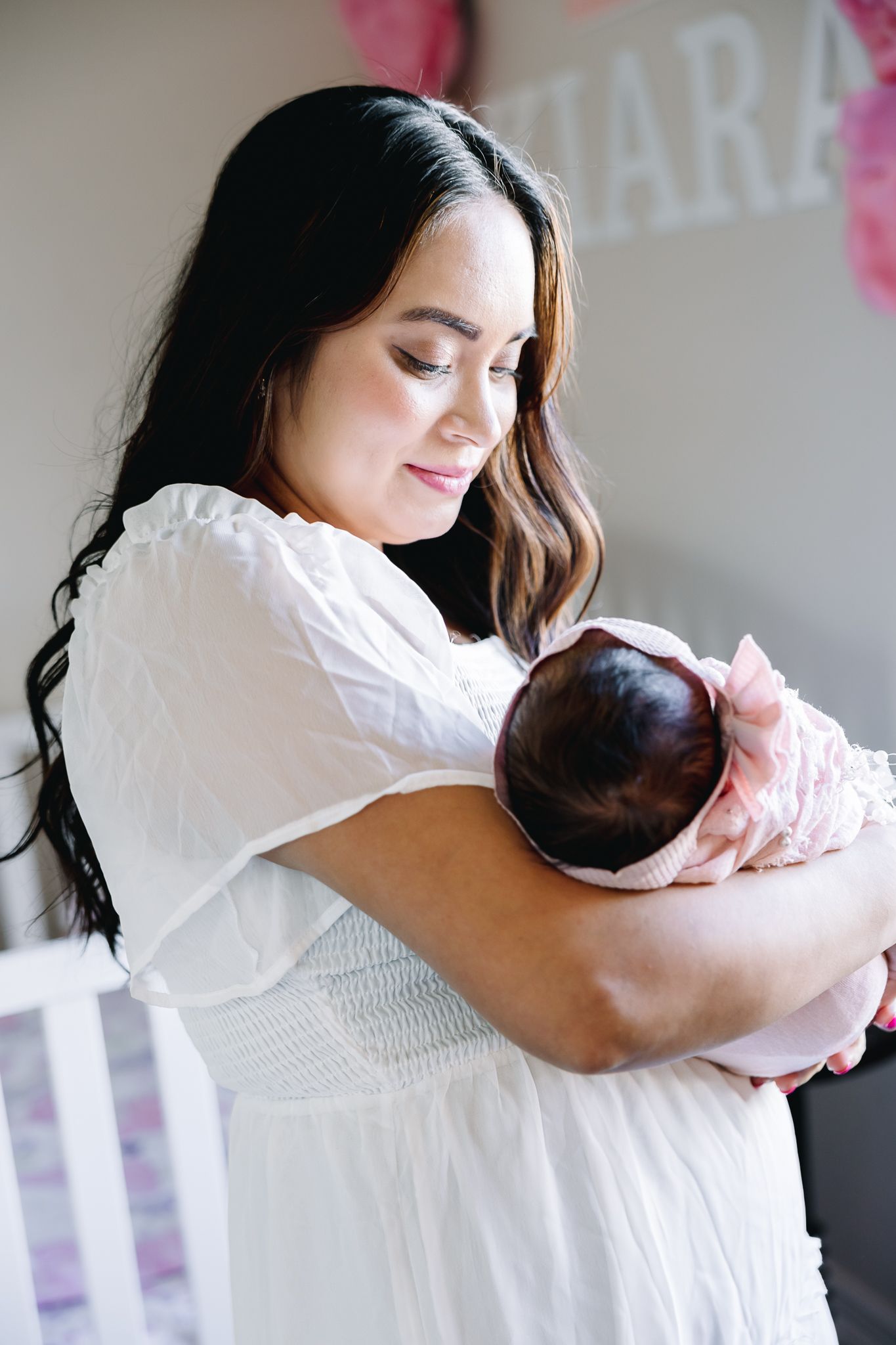 newborn lifestyle photoshoot of baby girl in her crib. Greeley colorado new born photography
