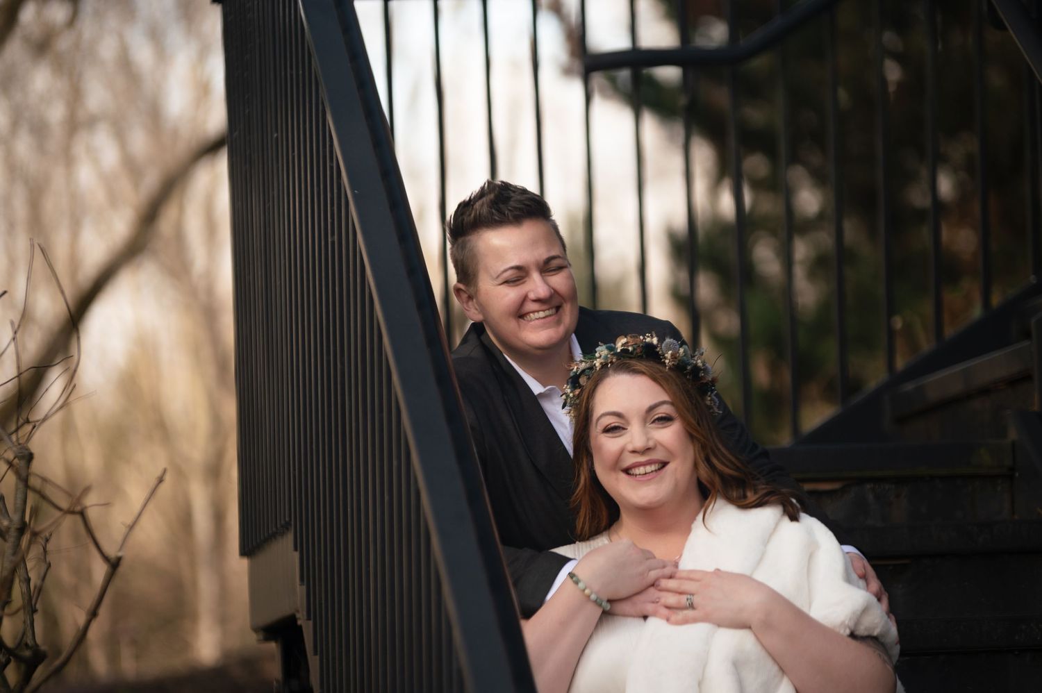A wedding couple share a romantic moment together on an outdoor staircase with black railings in Canton, Ohio.