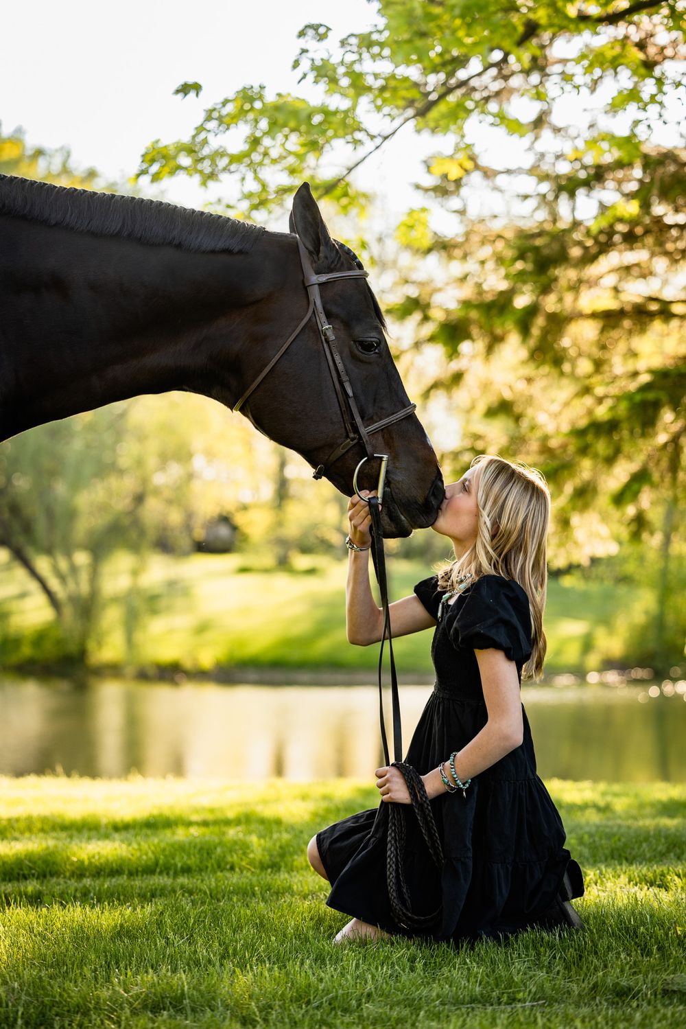 Beautiful horse photoshoot in a lush green field during golden hour sunset.