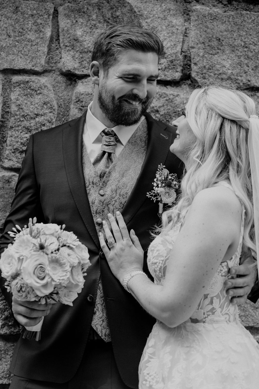A couple shares intimate moments during their wedding photoshoot outdoors.