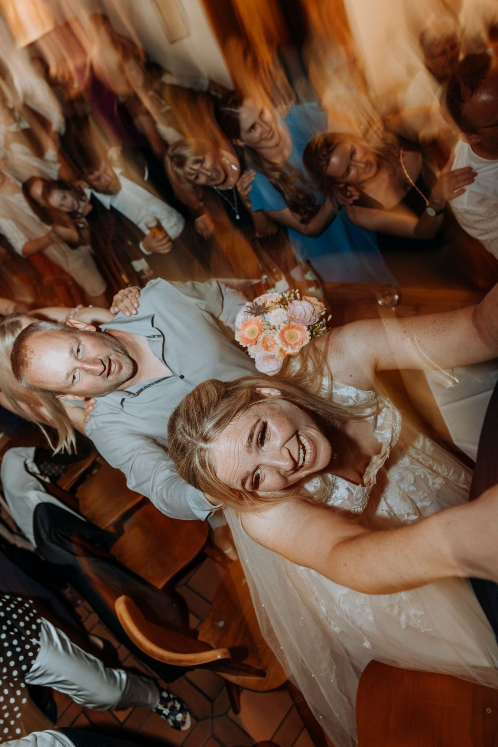 Dynamic dance floor moments captured at a wedding reception with motion blur effects.