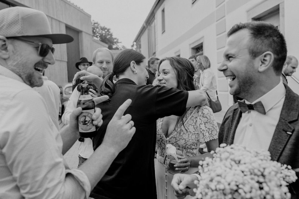 Black and white candid wedding celebration photos showing joyful moments.